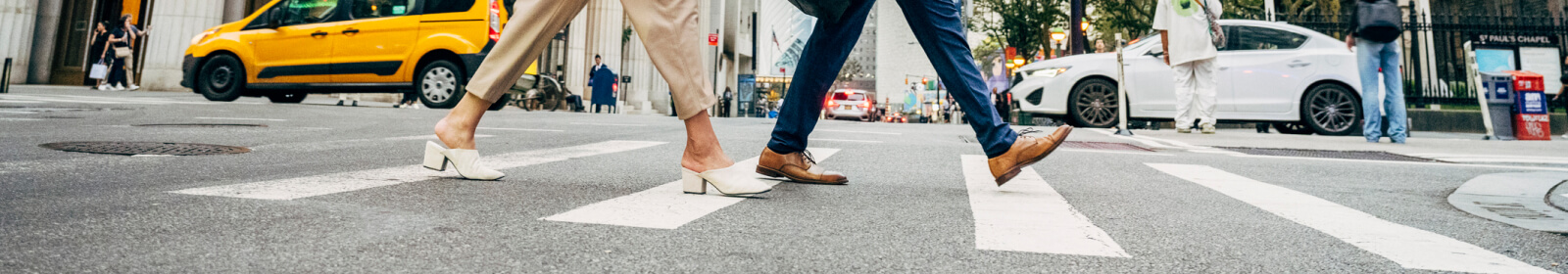Businesspeople walking across NYC street