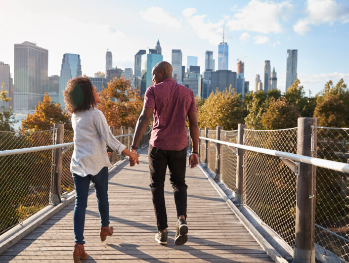 Couple walking on bridge near New York City